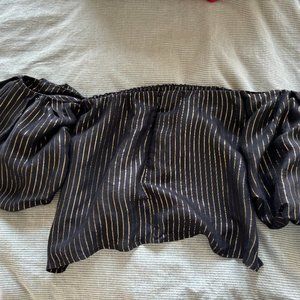 Off-the-shoulder black dress with gold embellished lines